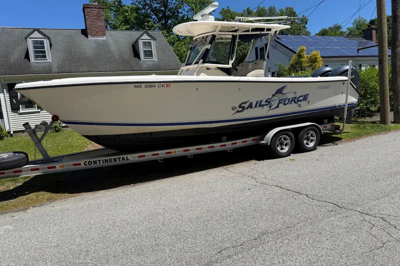 Slide: The Image of 2011 Pursuit C 280 Center Console boat on trailer, parked near a house. - 17