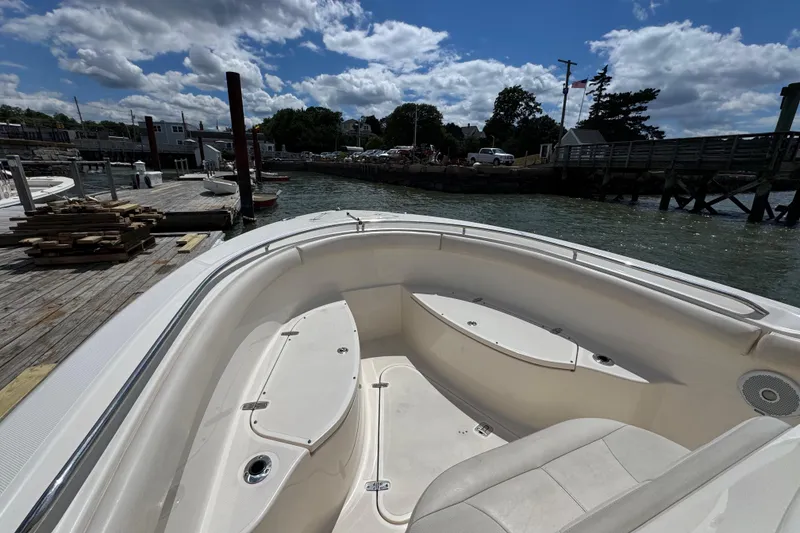 Slide: The Image of 2011 Pursuit C 280 Center Console boat docked at a marina under a partly cloudy sky. - 8