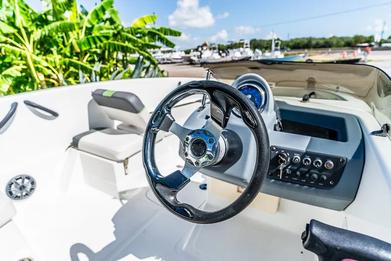 Slide: The Image of The image shows the cockpit of a Tracker Tahoe boat with a modern steering wheel and dashboard. - 13