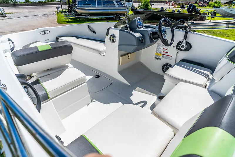 Slide: The Image of Interior view of a 2021 Tracker Tahoe boat with white and green seating. - 11