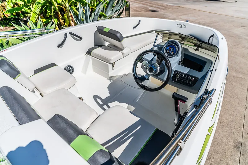 Slide: The Image of The image shows the cockpit of a 2021 Tracker Tahoe boat with modern seating and controls. - 14