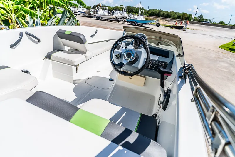 Slide: The Image of The image shows the cockpit of a 2021 Tracker Tahoe boat with modern seating and steering wheel. - 12
