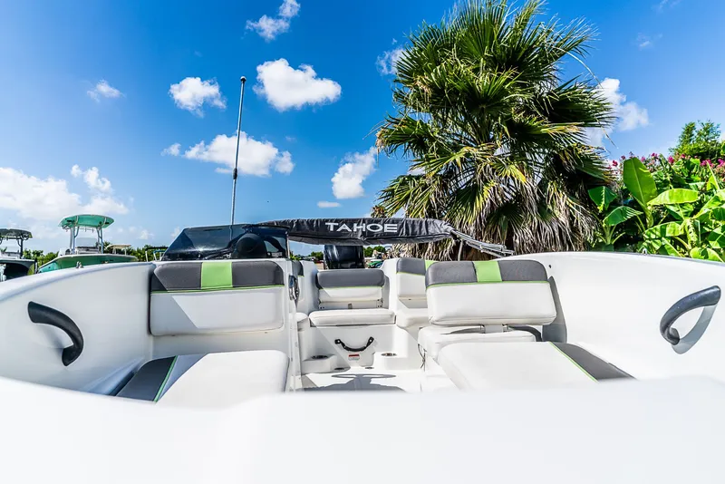 Slide: The Image of The image shows the interior of a Tracker Tahoe boat with white seats and green accents. - 8