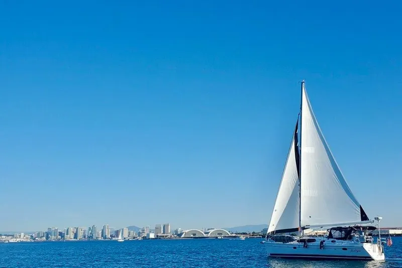 Slide: The Image of Sailing yacht Hunter 45 Deck Salon 2008 on blue ocean with city skyline backdrop. - 101