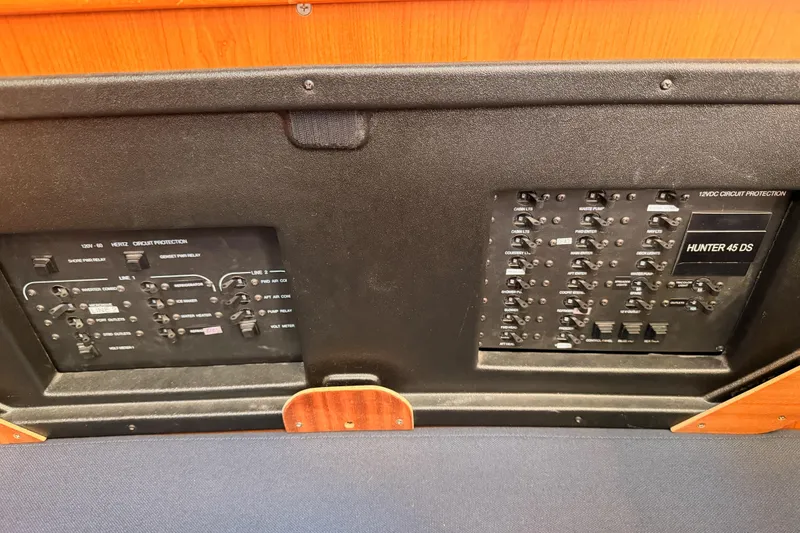 Slide: The Image of Electrical panel of a 2008 Hunter 45 Deck Salon yacht, featuring circuit protection switches. - 103
