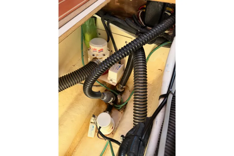 Slide: The Image of Engine compartment of 2008 Hunter 45 Deck Salon with wiring and components visible. - 107