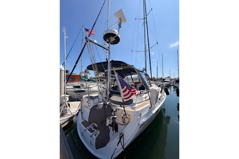 Slide: The Image of 2008 Hunter 45 Deck Salon sailboat docked in marina with American flag. - 11