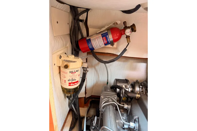 Slide: The Image of Engine compartment of 2008 Hunter 45 Deck Salon with fire extinguisher and fuel filter. - 110