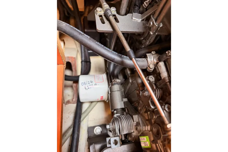 Slide: The Image of Engine components of a 2008 Hunter 45 Deck Salon sailboat, featuring hoses and mechanical parts. - 111
