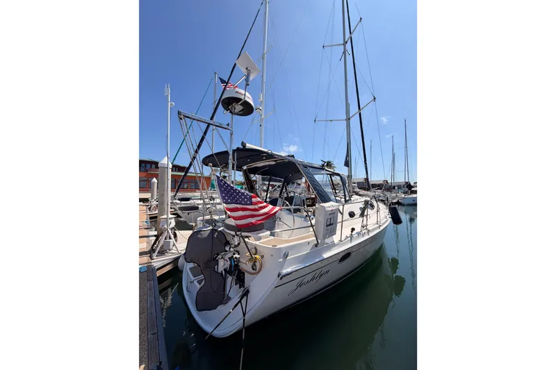 Slide: The Image of 2008 Hunter 45 Deck Salon sailboat docked at marina with American flag. - 12