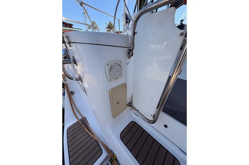 Slide: The Image of 2008 Hunter 45 Deck Salon yacht deck with railing and hatch details. - 14