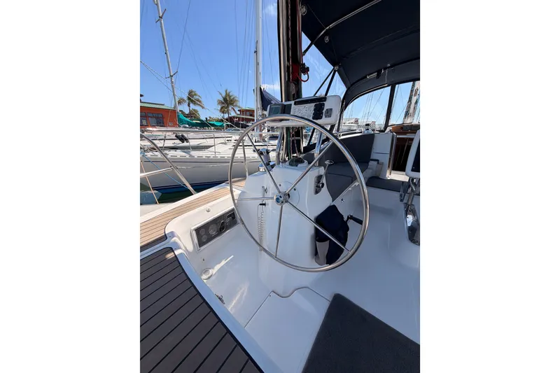 Slide: The Image of 2008 Hunter 45 Deck Salon sailboat cockpit with steering wheel and navigation instruments. - 17