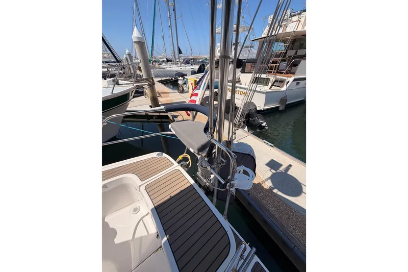 Slide: The Image of 2008 Hunter 45 Deck Salon yacht docked at marina, showcasing deck and rigging. - 18