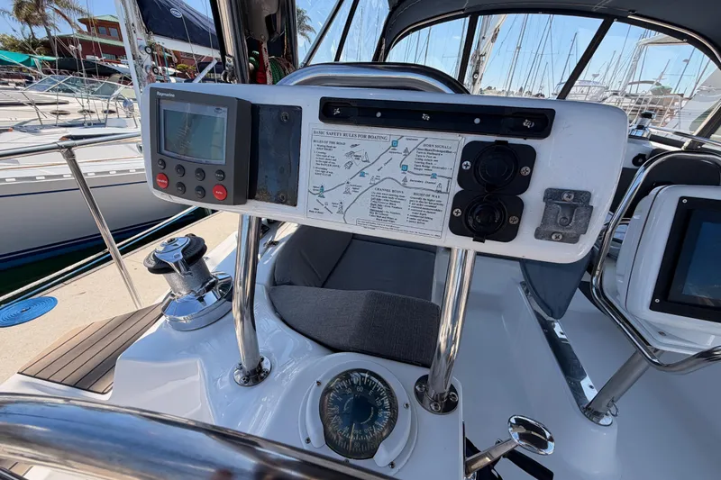 Slide: The Image of Cockpit of 2008 Hunter 45 Deck Salon sailboat with navigation equipment and safety instructions. - 21