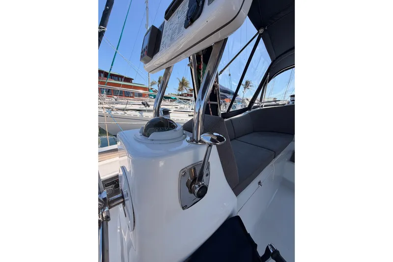 Slide: The Image of 2008 Hunter 45 Deck Salon cockpit with navigation instruments and seating, docked at marina. - 22