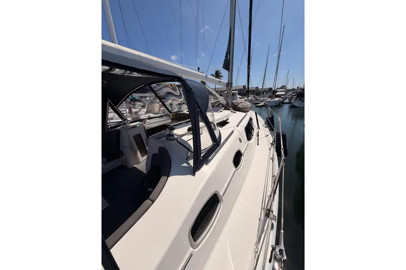 Slide: The Image of 2008 Hunter 45 Deck Salon sailboat docked in a marina under clear blue skies. - 28