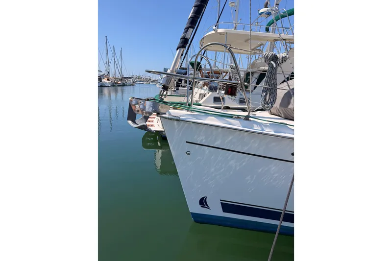 Slide: The Image of 2008 Hunter 45 Deck Salon yacht docked in a marina, reflecting on calm water. - 3