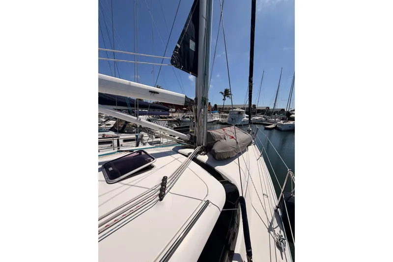 Slide: The Image of 2008 Hunter 45 Deck Salon sailboat docked in marina under clear blue sky. - 30
