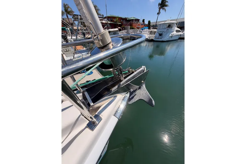 Slide: The Image of 2008 Hunter 45 Deck Salon yacht anchored in marina, featuring stainless steel bow and anchor. - 33