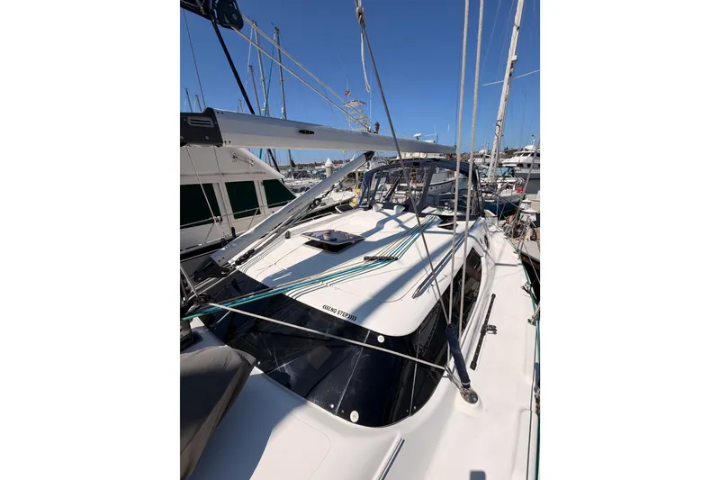 Slide: The Image of 2008 Hunter 45 Deck Salon sailboat docked at marina under clear blue sky. - 36