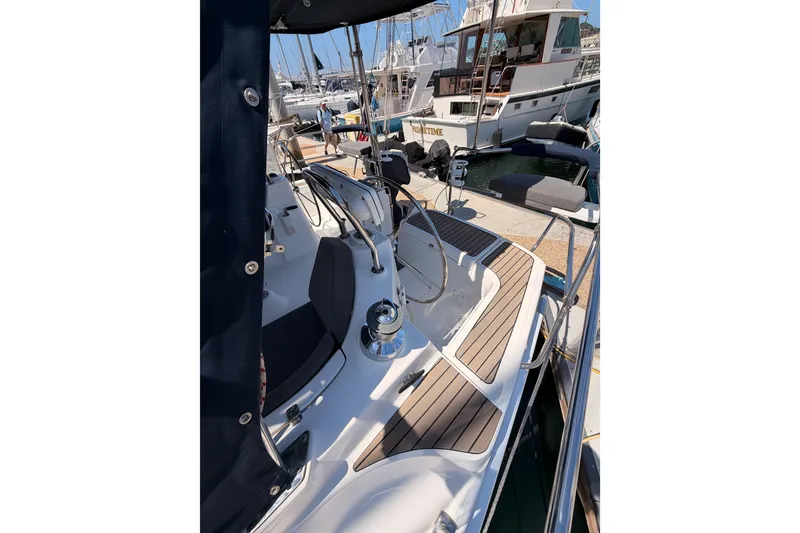 Slide: The Image of 2008 Hunter 45 Deck Salon yacht cockpit with wooden flooring and steering wheel at marina. - 39