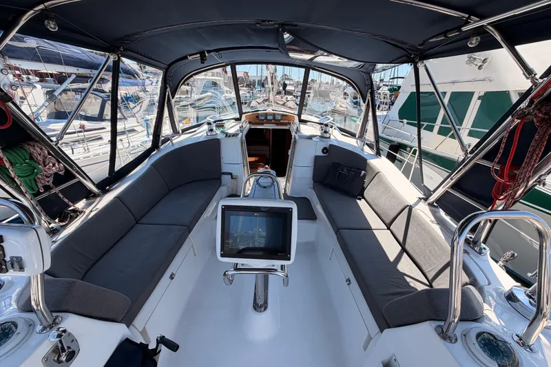 Slide: The Image of 2008 Hunter 45 Deck Salon yacht cockpit with seating and navigation equipment in marina. - 40