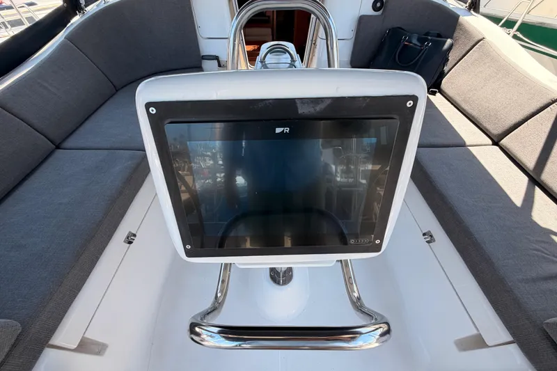 Slide: The Image of Cockpit of 2008 Hunter 45 Deck Salon with navigation display and cushioned seating. - 41