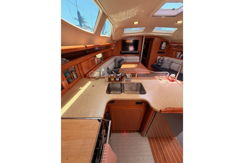 Slide: The Image of Interior of 2008 Hunter 45 Deck Salon yacht with modern kitchen and cozy seating area. - 55