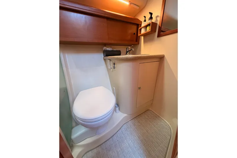 Slide: The Image of 2008 Hunter 45 Deck Salon bathroom with toilet, sink, and storage cabinet. - 59