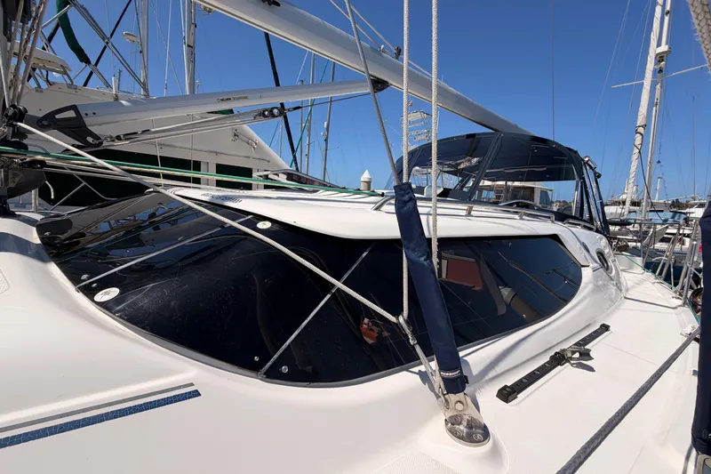 Slide: The Image of 2008 Hunter 45 Deck Salon sailboat with sleek design and rigging, docked in marina. - 6