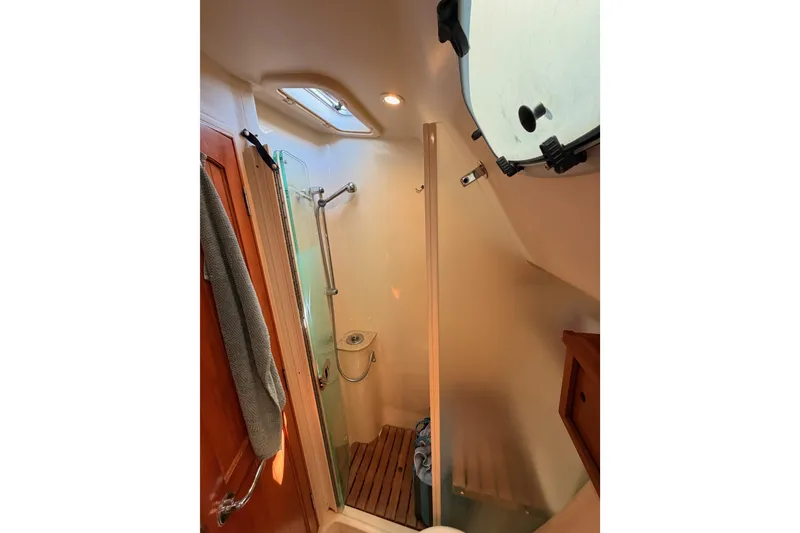 Slide: The Image of Bathroom interior of 2008 Hunter 45 Deck Salon yacht, featuring shower and wooden accents. - 60