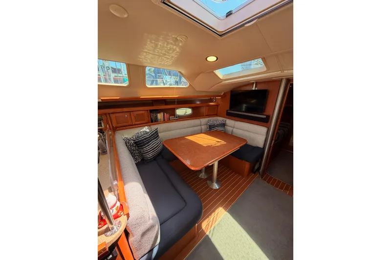 Slide: The Image of Interior of 2008 Hunter 45 Deck Salon with cozy seating and wooden table. - 68