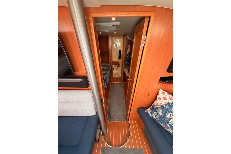 Slide: The Image of Interior of 2008 Hunter 45 Deck Salon, featuring cozy seating and wooden finishes. - 74