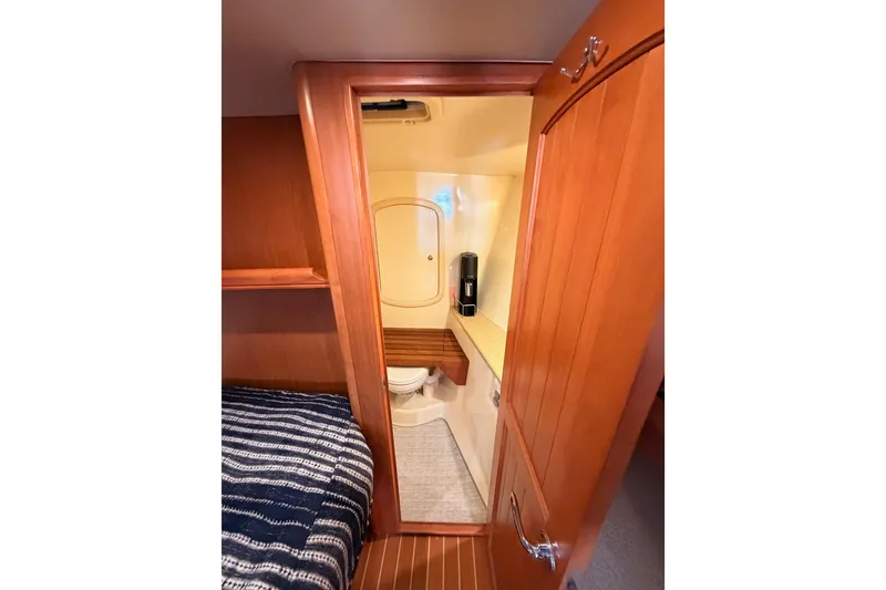 Slide: The Image of Interior view of 2008 Hunter 45 Deck Salon yacht bathroom with wooden cabinetry. - 78