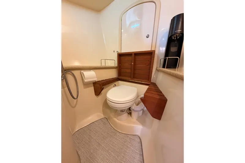 Slide: The Image of Bathroom interior of 2008 Hunter 45 Deck Salon yacht, featuring toilet and wooden accents. - 80