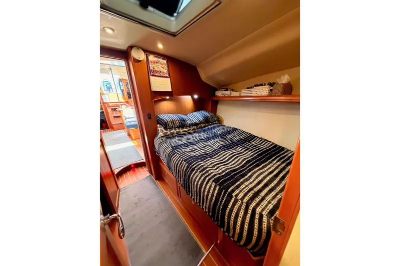 Slide: The Image of Cozy cabin interior of 2008 Hunter 45 Deck Salon yacht with striped bedding. - 82
