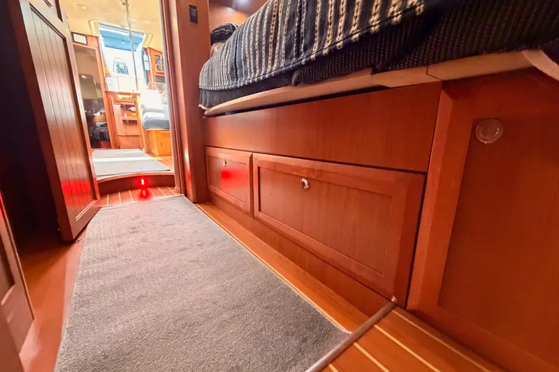 Slide: The Image of Interior of 2008 Hunter 45 Deck Salon yacht with wood cabinetry and cozy bedding. - 83