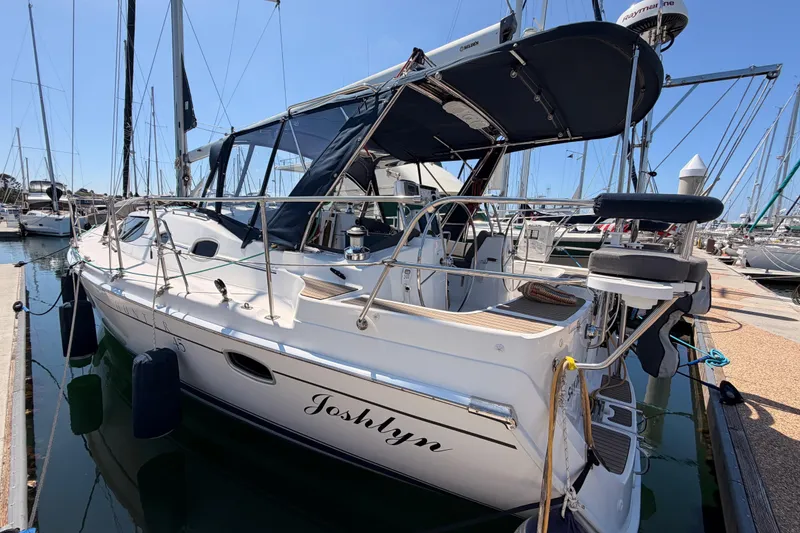 Slide: The Image of 2008 Hunter 45 Deck Salon sailboat docked in marina, featuring sleek design and spacious deck. - 9