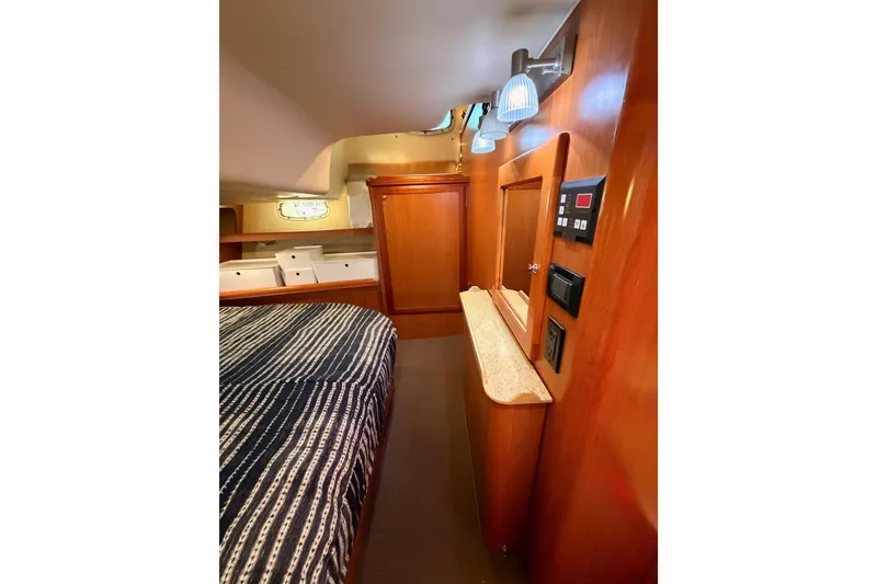 Slide: The Image of Interior of 2008 Hunter 45 Deck Salon with wood paneling and cozy sleeping area. - 91