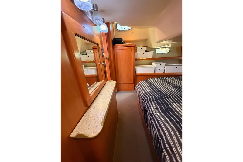 Slide: The Image of Interior of 2008 Hunter 45 Deck Salon yacht with wood finish and cozy sleeping area. - 95