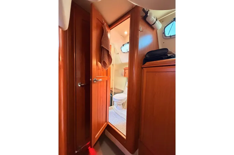 Slide: The Image of Interior view of 2008 Hunter 45 Deck Salon yacht bathroom with wooden cabinetry. - 97