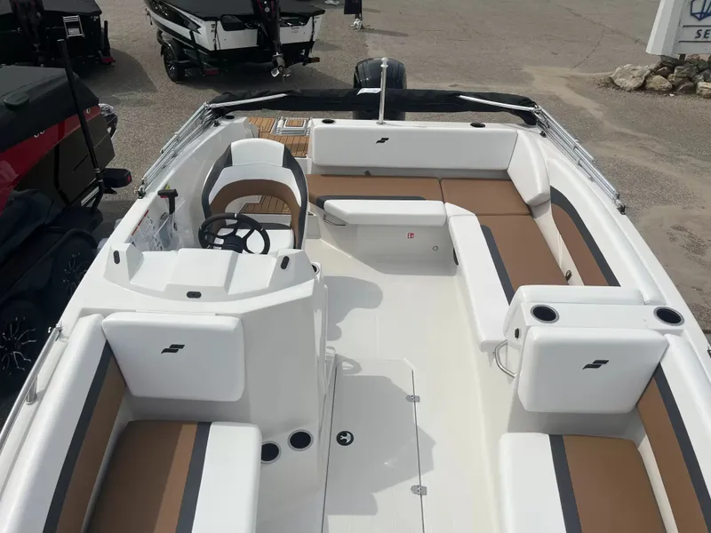 Slide: The Image of The image shows a 2027 Starcraft SVX 171 OB boat with white and brown seating. - 8
