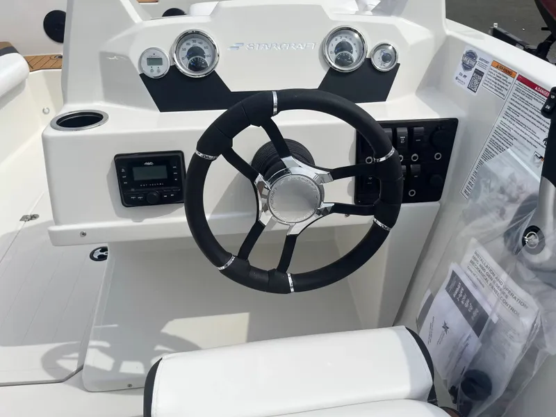 Slide: The Image of The image shows the helm of a Starcraft SVX 171 OB boat with modern instruments. - 9