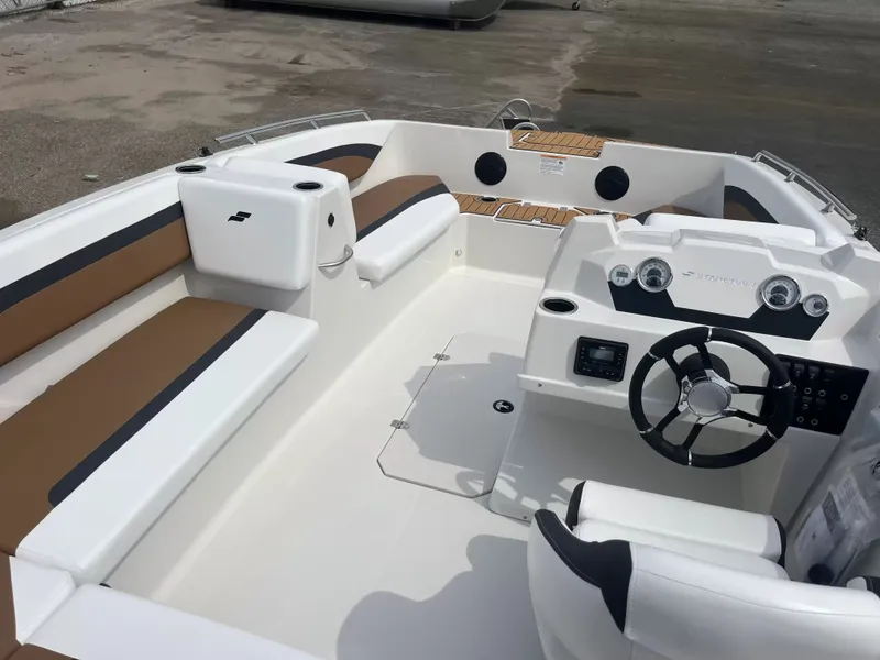 Slide: The Image of The image shows the cockpit of a 2027 Starcraft SVX 171 OB with modern instruments and seating. - 11