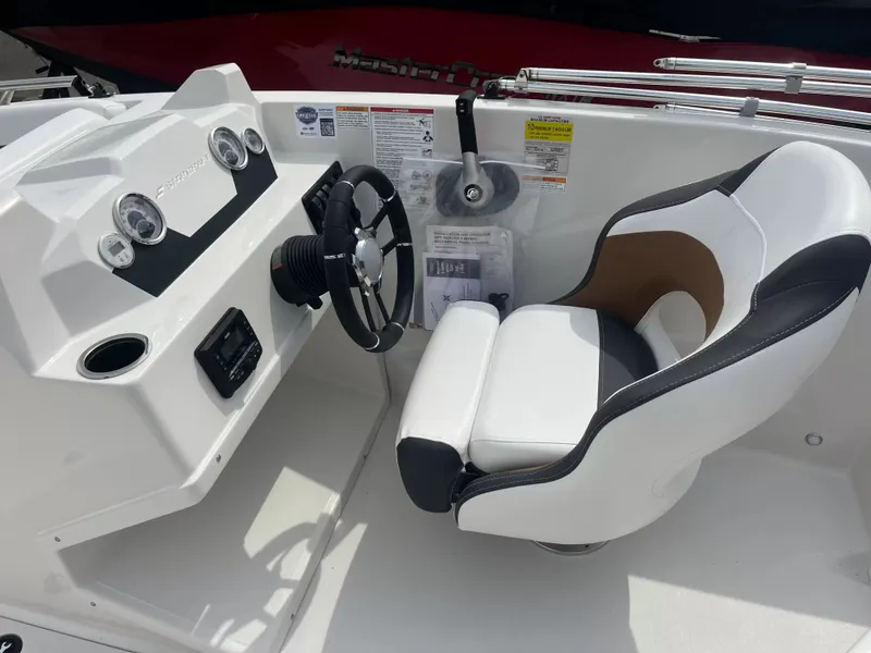 Slide: The Image of The image shows the cockpit of a 2027 Starcraft SVX 171 OB with a modern helm and cushioned seat. - 10