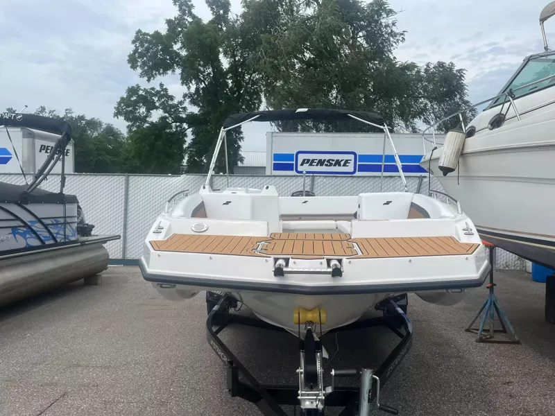 Slide: The Image of A 2027 Starcraft SVX 171 OB boat on a trailer, surrounded by other boats. - 2