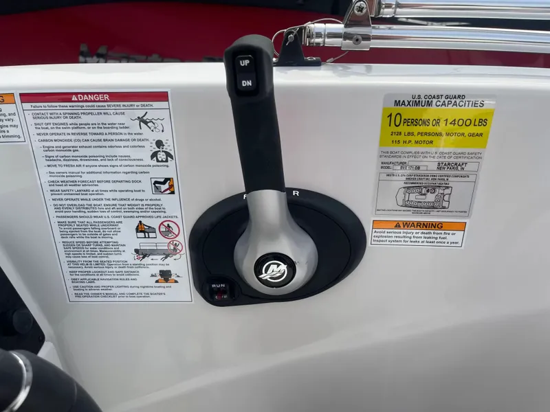 Slide: The Image of Close-up of a control lever with warning labels and capacity information on the side. - 12