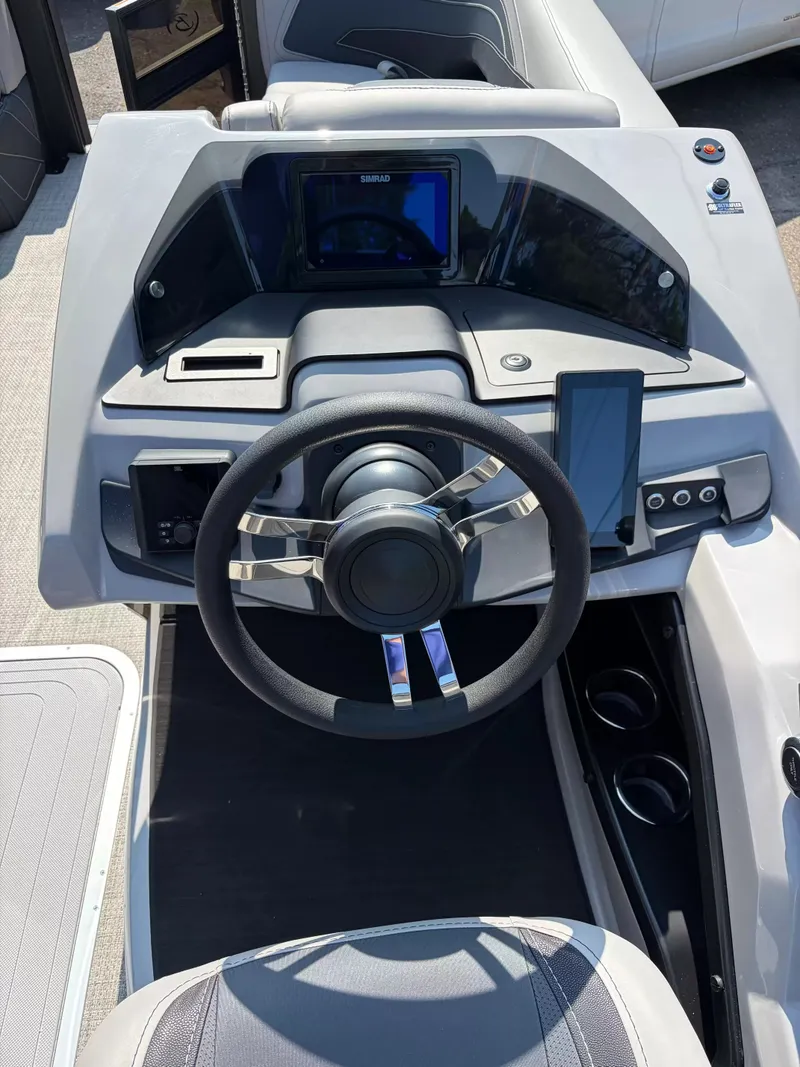 Slide: The Image of The image shows the helm of a 2027 Barletta CABRIO C22UC/TT boat. - 13