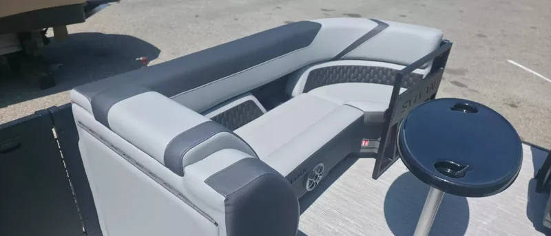 Slide: The Image of Sylvan X3 ULZ FG/TT 2026: Sleek gray and black seating area with a table. - 4