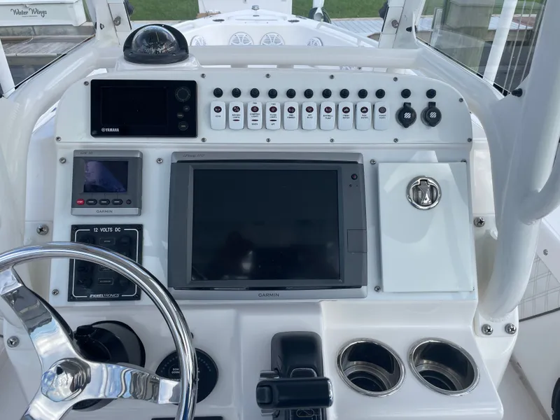Slide: The Image of The image shows the helm of a 2012 Everglades 243 Center Console boat. - 10